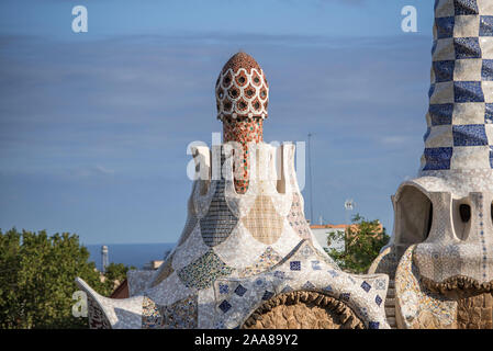 Antoni Gaudi's masterpiece, beautifully crafted Park Güell in Barcelona, Spain, its gardens, clolourful mosaics, houses and the view over the city. Stock Photo