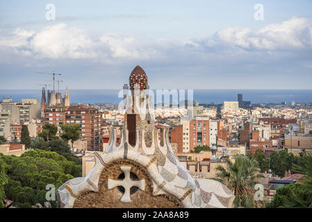 Antoni Gaudi's masterpiece, beautifully crafted Park Güell in Barcelona, Spain, its gardens, clolourful mosaics, houses and the view over the city. Stock Photo