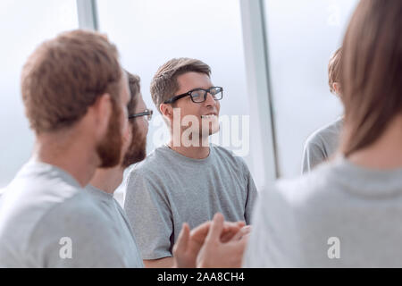 team of young people greeted the speaker with applause Stock Photo