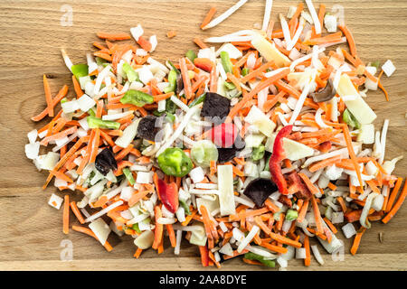 Chinese vegetables sliced in strips on wooden board. Stock Photo