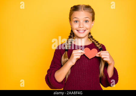 Close-up portrait of her she nice attractive lovely girlish cute cheerful cheery glad pre-teen girl holding in hands showing small heart isolated on Stock Photo