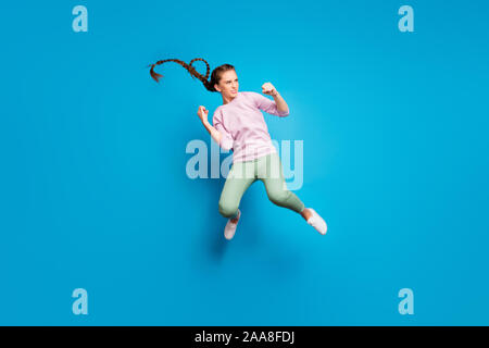 Full size profile side photo of serious youngster girl have fighting battle jump kick legs fists enemy want win wear pink pullover white youth Stock Photo