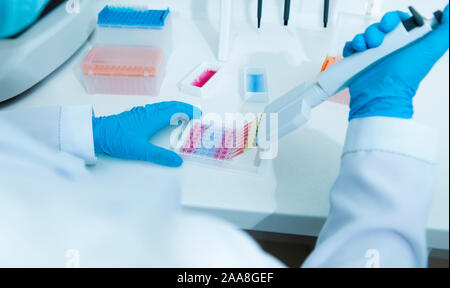 Woman medical assistant working with colored samples Stock Photo