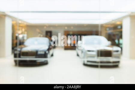 blur image of Commercial luxury cars displayed in luxury showroom of car shop for background usage. Stock Photo