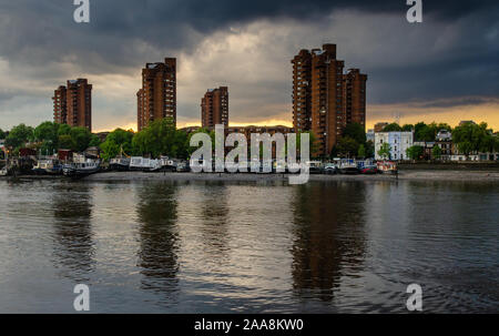 London, England, UK - May 13, 2014: The tower blocks of Chelsea's World's End council housing estate are reflected in the River Thames in west London. Stock Photo