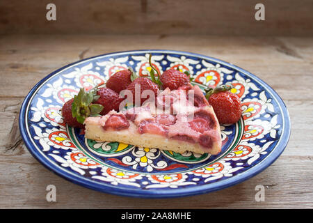 Round circle strawberry pie pasty cake tart cheesecake with fresh berries strawberries slice on plate dish retro vintage on solid wood country table. Stock Photo