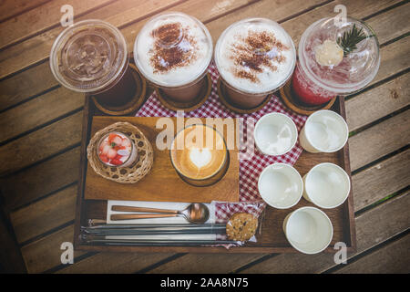 Coffeeshop drink mix set about cold and hot coffee cocoa and cup cake in wooden plate serve. Stock Photo