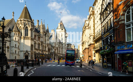 London, England, UK - July 8, 2013: A double-decker bus stops at a pedestrian crossing outside the Royal Courts of Justice on London's Fleet Street. Stock Photo