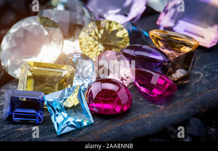 Collection mix colorful of gemstones jewelry on dark stone. Stock Photo
