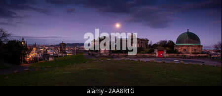 Edinburgh, Scotland, UK - January 11, 2012: The moon sets over Edinburgh's Calton Hill Observatory at dawn.