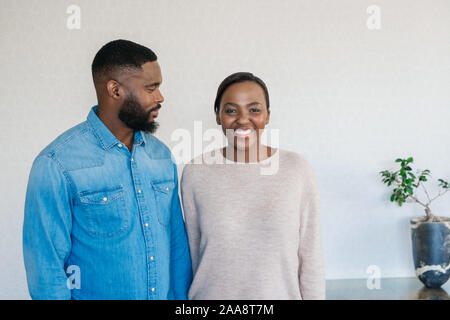 Smiling African American couple standing at home together Stock Photo