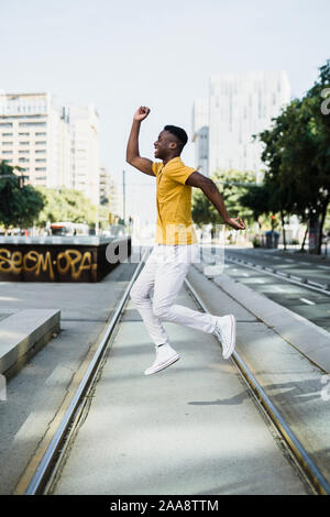 Portrait of a boy jumping in the city, concept of happiness Stock Photo