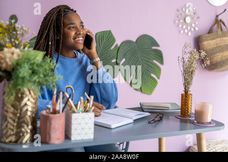 young businesswoman talking and working at home Stock Photo