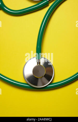Stethoscope on a yellow table Stock Photo