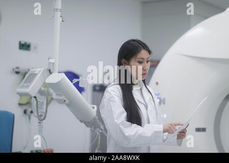 asia woman doctor checking protocol in a hospital Stock Photo