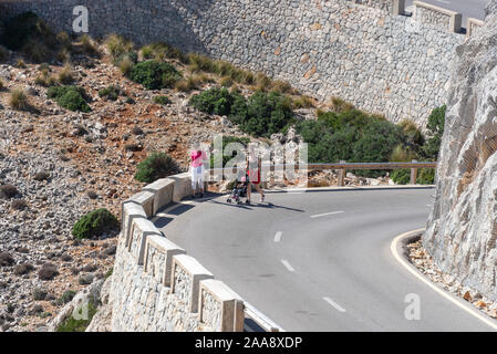 Far De Formentor, Spain. 08th Oct, 2019. Two women walk with a pram up the mountain road to the lighthouse Far de Formentor, the northernmost point of the Balearic island Mallorca. Credit: Stephan Schulz/dpa-Zentralbild/ZB/dpa/Alamy Live News Stock Photo