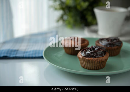 Three muffins with chocolate cream and fresh coffee Stock Photo