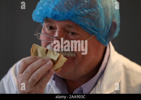 Judge David Kyles smells a Scotch pie during judging at the 2020 World Scotch Pie Championship at Carnegie Conference Centre, Dunfermline. Stock Photo