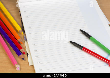 Opened business diary, pens  and markers Stock Photo