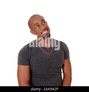 Image of happy african american guy smiling and sitting on chair with ...