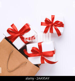 Many Christmas gifts with red ribbons and shopping bag Stock Photo