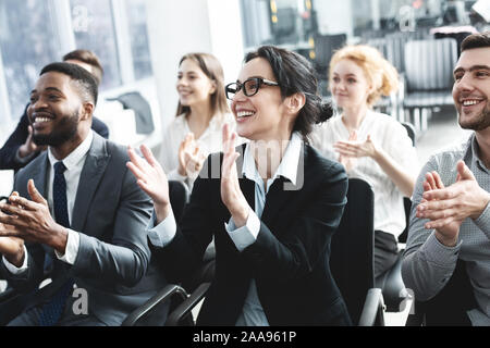 Business lecture. Happy executives applauding to speaker Stock Photo