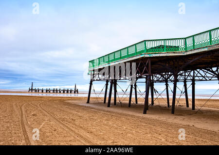 The remains of the old wooden pier with detail of St Annes pier in Lytham St Annes Lancashire UK Stock Photo