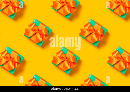Pattern with stylish gift on a trendy orange background. Present for St. Valentine's day, engagements, Mother's Day, birthday, New Year, Christmas, holidays Stock Photo