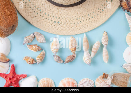 The word sun written in shells on blue background Stock Photo