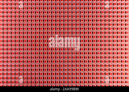 Real texture of pink rubber squares close up, illuminated with light. Stock Photo