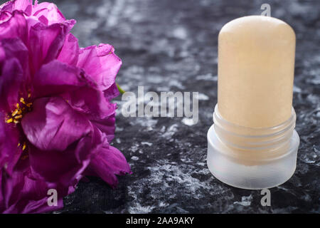 Deodorant for women and flowers on table Stock Photo