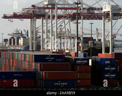 AJAXNETPHOTO. SEPTEMBER, 2019. DUNKERQUE, FRANCE. - FREIGHT - CONTAINER BOXES STACKED ON THE QUAY WITH CONTAINER SHIPS LOADING AND DISCHARGING IN BACKGROUND AT TERMINAL DES FLANDRES.PHOTO:JONATHAN EASTLAND/AJAX REF:GX8 192609 20545 Stock Photo