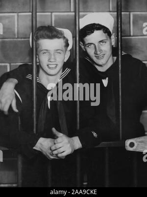 Two US Navy sailors pose in the pretend brig, ca. 1944. Stock Photo