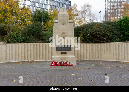 Red poppy wreathes laid around a War memorial on Remembrance Sunday Stock Photo