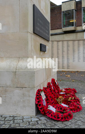 Red poppy wreathes laid around a War memorial on Remembrance Sunday Stock Photo