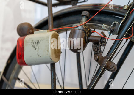 An old bike or bicycle dynamo system used to generate power to illuminate a lights Stock Photo