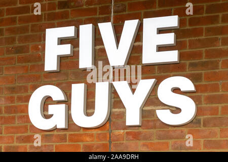 The sign of a Five guys restaurant on a brick building Stock Photo