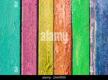 Background wooden texture of a multi-colored fence. Boards of various bright colors Stock Photo