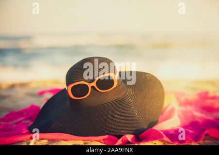 Sun hat glasses on a background of the sea. Vacation concept. Stock Photo