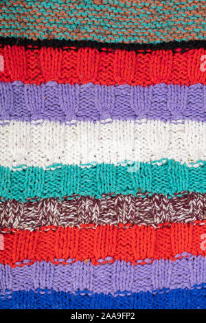 Knitted multi-colored texture. Background knitted stripes close-up. Stock Photo