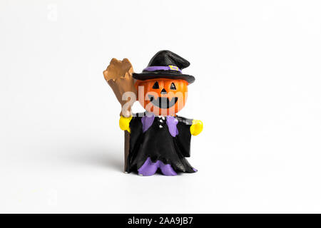 Wizard doll halloween pumpkin with a broom on the white background. Stock Photo