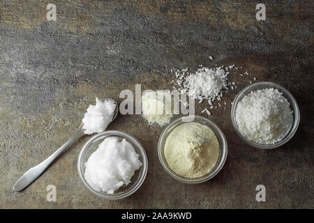 natural and organic coconut oil, coconut flour, coconut shreds ingredients in glass bowls Stock Photo