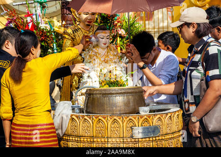 Buddhist People Take Part In The Ritual Of Pouring Water Over Buddhist Statues, The Shwedagon Pagoda, Yangon, Myanmar. Stock Photo