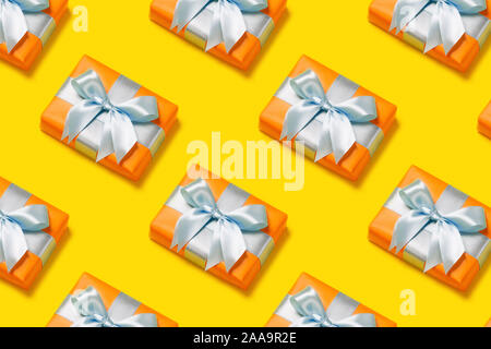 Pattern with stylish gift on a trendy yellow background. Present for St. Valentine's day, engagements, Mother's Day, birthday, New Year, Christmas, holidays Stock Photo