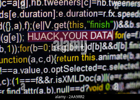 Macro photo of computer screen with program source code and highlighted HIJACK YOUR DATA inscription in the middle. Script on the screen with virus in Stock Photo