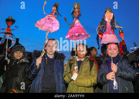 Greenwich, London, UK, 20th November 2019. Local school children with their '9 ladies dancing' lanterns. The annual Lantern Parade in the Royal Borough of Greenwich, this year featuring lanterns based on 'The 12 Days of Christmas', sees children from several local schools parade their handmade lanterns. The parade proceeds through the grounds of the Old Royal Naval College, past the historic Cutty Sark clipper, and into Greenwich Market for the big Christmas Lights switch. Credit: Imageplotter/Alamy Live News Stock Photo
