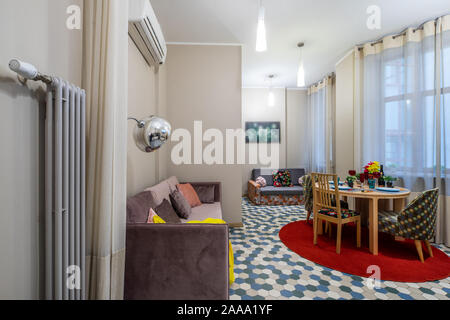 Cozy sofa. Spacious apartment. Served table. Stock Photo