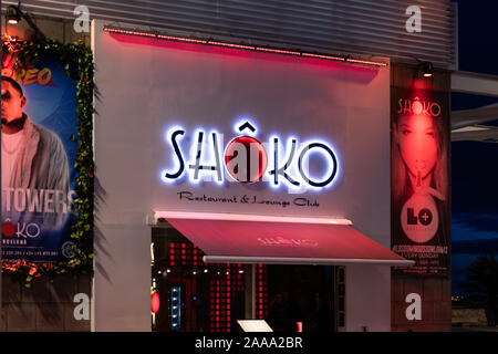 Barcelona, Spain - Nov 15, 2019: Entrance of Shoko restaurant and lounge club illuminated at night. The club is located in Passeig Maritim in front of Stock Photo