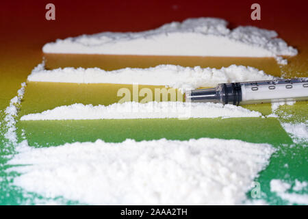 Flour that should look like a white drug with macro lens photographed in front of colorful gradient in the studio Stock Photo