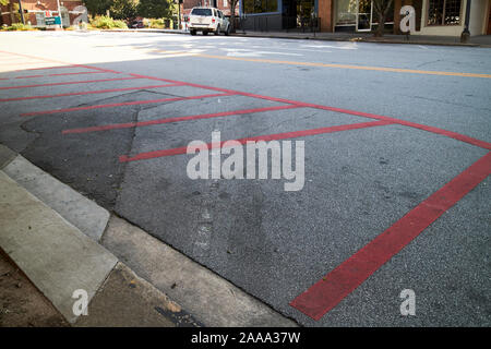 red painted no parking area of street in downtown athens georgia usa Stock Photo